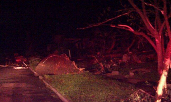 Night time image of trees pushed down, tearing ground up with its roots.